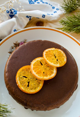 Carrot cake with chocolate topping and caramelized oranges