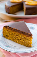Carrot cake with chocolate topping and caramelized oranges