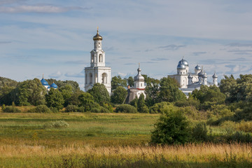 Fototapeta na wymiar Old Orthodox monastery in the summer landscape. Yuriev Monastery in the neighborhood Veliky Novgorod