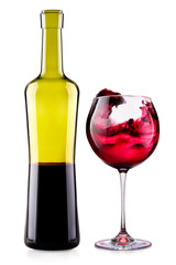 Elegant red wine glass and bottle isolated