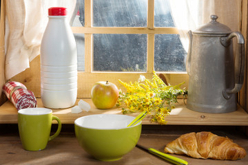 Breakfast with milk, croissant, and apple