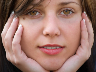 Beautiful girl with hands in front of her face
