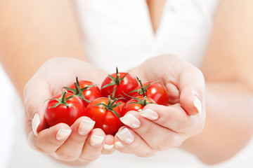 Young woman holding cherry tomatos