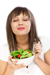 Young woman eating fresh salad