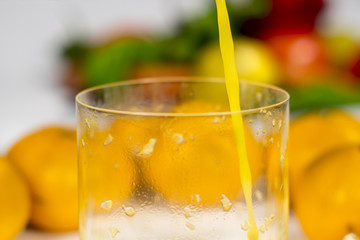 Detail view of orange's juice jet falling in a glass