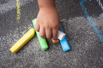 Hand hold colored chalk