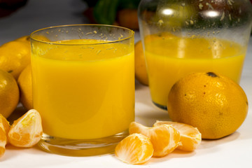 Glass and jar of natural tangerine orange juice © Alonso Aguilar