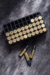 Scattering of small caliber cartridges on a wooden background