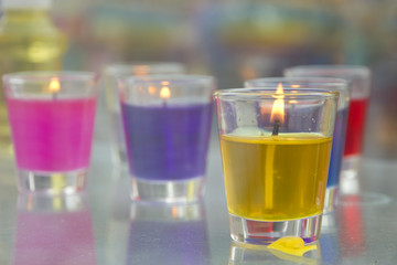 Stock Photo:.Close-up of yellow and red candles in glass holders