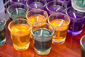 Stock Photo:.Close-up of yellow and red candles in glass holders
