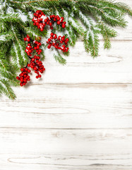 Fototapeta na wymiar Christmas tree branch with red berries. Winter holidays decorati