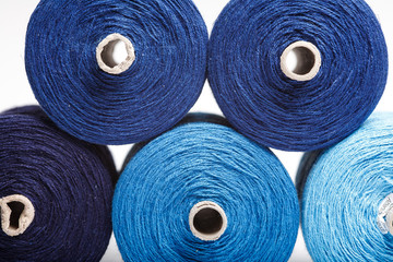 Blue sewing threads as a color background close up