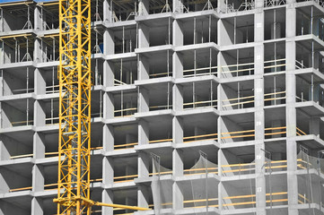 Crane and building construction site with balcony