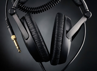 Modern headphones over black background