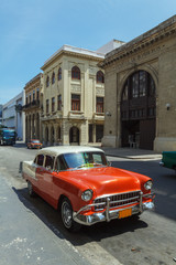 Fototapeta na wymiar Vintage red car on the street of old city, Havana, Cuba