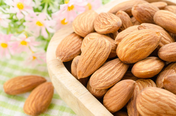 Almond in wooden cup.