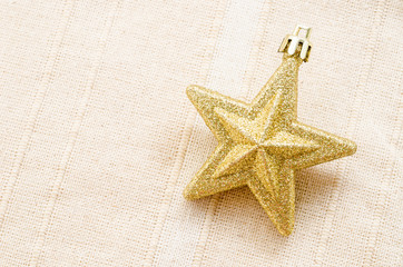 Gold five pointed star christmas decoration.
