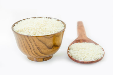 Raw rice in wooden bowl and spoon.