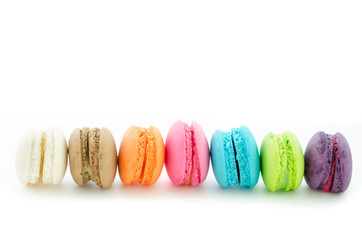 Colorful macarons on white background.