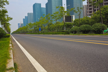 Empty road surface with modern city buildings background