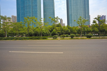 Empty road surface with modern city buildings background