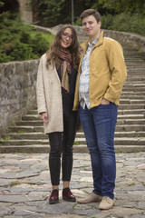 Fototapeta premium young beautiful couple in 20s posing, looking at camera.