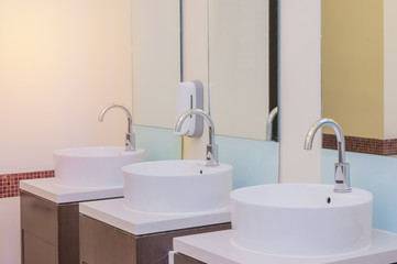 Fototapeta na wymiar white basins in bathroom interior with granitic tiles