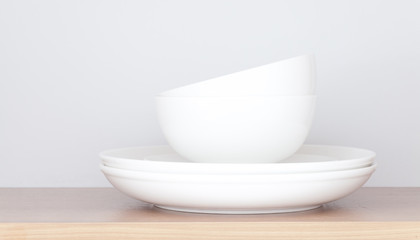 White plate and white bowl in kitchen cabinet