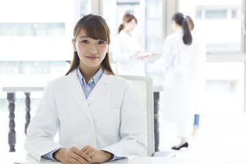 Fototapeta premium Women's portrait wearing a white coat