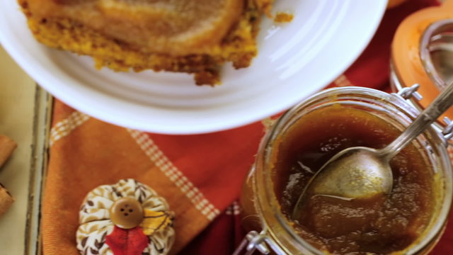 Homemade pumpkin butter with pumpking bread on the table