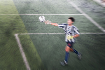 blurry soccer and football player training and playing football