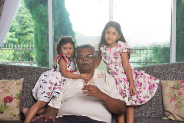 portrait of indian granparent and his grandchildren