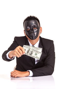 businessman with black glossy fancy mask holding bank note