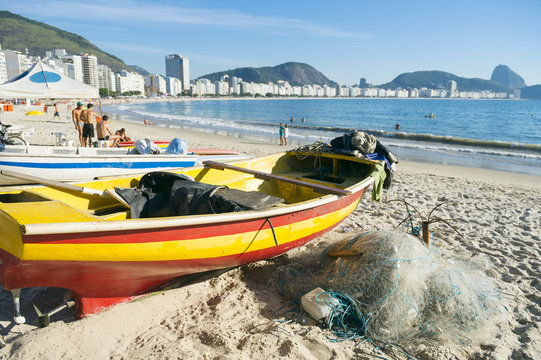 Colorful fishing boat and net on scenic view of Copacabana Beach in Rio de Janeiro, Brazil
