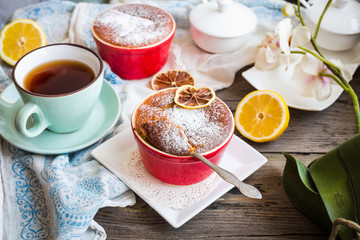 lemon pudding with red plates on a white tablecloth