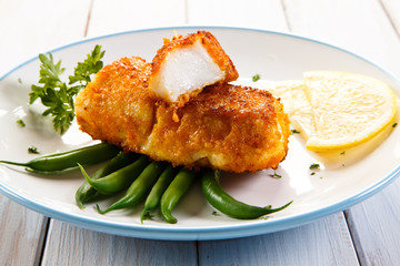 Fish dish - fried fish fillets and vegetables 