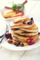 Pancakes with honey, hazelnuts and currants