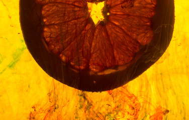 close up of a grapefruit slice in water