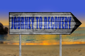 Journey to Recovery wooden sign with on a beach background