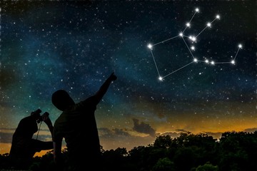 Pegasus constellation on night sky. Astrology concept. Silhouettes of adult man and child observing...