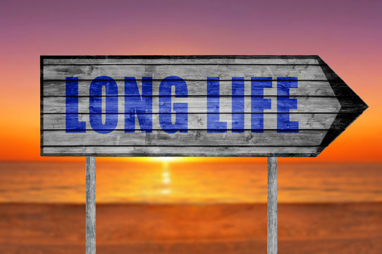 Long Life wooden sign with a beach background
