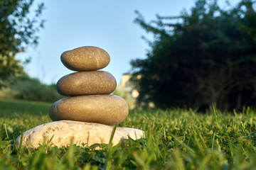 balancing stones on the grass
