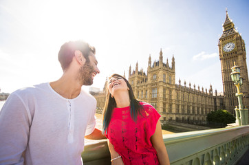 Young couple on vacation laughing and playing in front of the Big Ben - London - Caucasian people -...