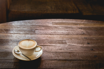 Hot art Latte Coffee in a cup on wooden table