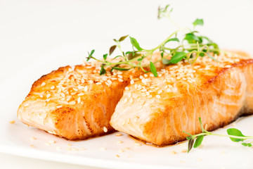 Grilled salmon on white plate