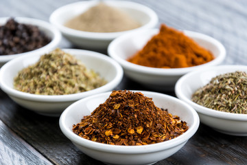Spices and herbs in  bowls.
