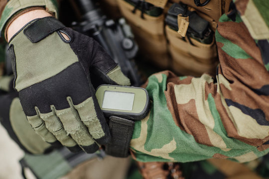 ranger holding gps in hand and determines the location of coordi