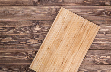 Obraz na płótnie Canvas Empty vintage cutting board on planks food background concept