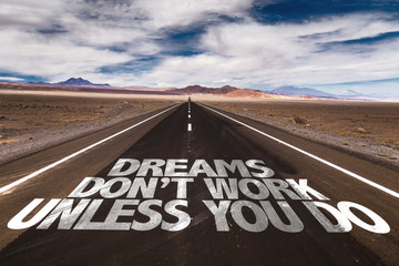Dreams Don't Work Unless You Do written on desert road