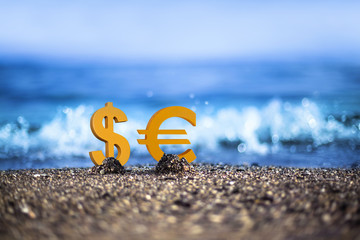 Dollar and Euro currency icons are standing on the wavy sea side